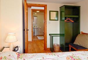 Double bedroom with wardrobe; bathroom on opposite side of the hallway